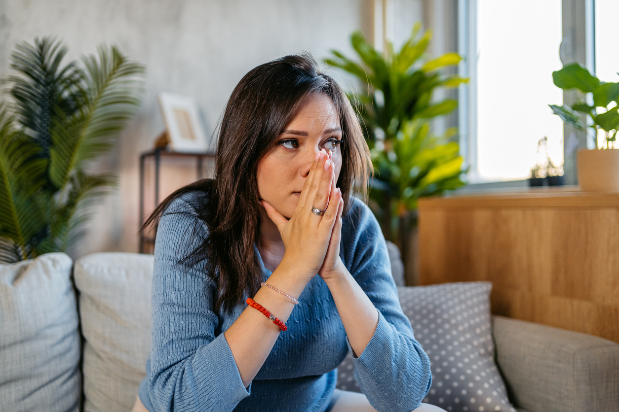 Sad Young Pregnant Woman Sitting On The Sofa At Home