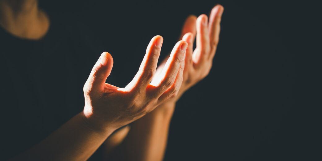 Dark Silence Of The Church, A Christian Lifts Their Hand In Prayer To God, A Symbol Of Worship, Faith, And Hope Embracing The Spiritual Concept Of Religion And Believing In Jesus Christ.