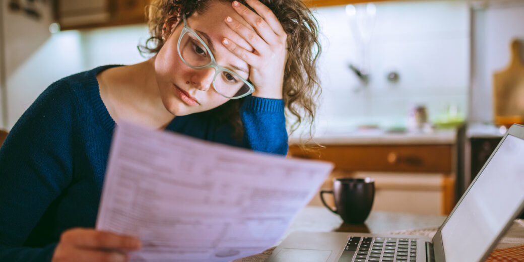 Woman Going Through Bills, Looking Worried