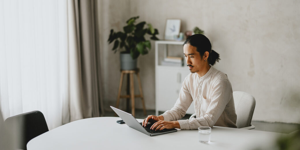 Business Professional Working On Laptop In Minimalist Office Space