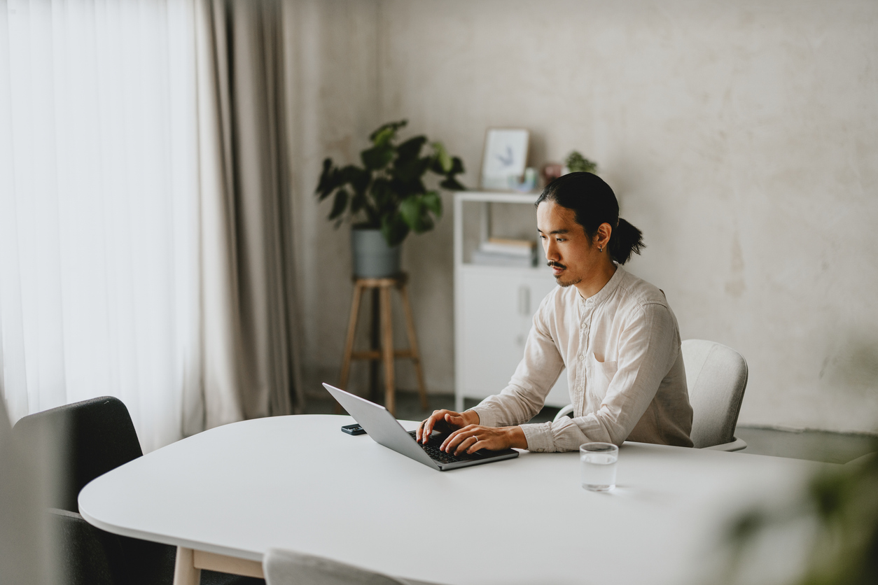 Business Professional Working On Laptop In Minimalist Office Space